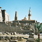 General view of Luxor Temple, Front end, from the Corniche. Photo taken by Hajor, Dec. 2002, licensed under the Creative Commons Attribution-Share Alike 1.0 Generic license.
