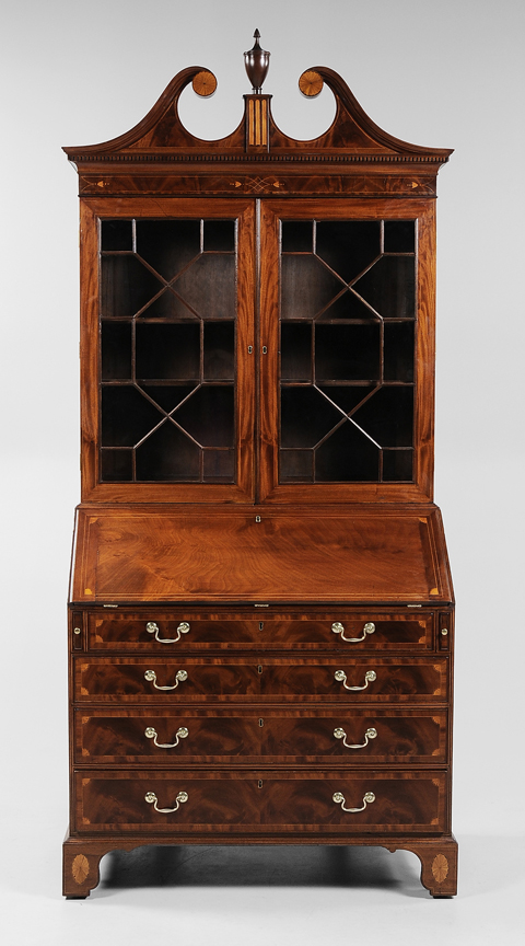 Standing 70 1/2 inches and 43 1/4 inches deep, this massive late 18th century Charleston desk and bookcase was recently conserved by David Beckford of Charleston, S.C.  In highly figured mahogany veneers and elaborate inlays, this important piece of Southern furniture sold for $86,250 (est. $60,000/$90,000). Image courtesy of Brunk Auctions.