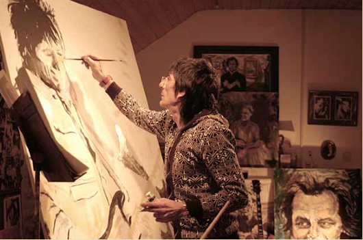 Rolling Stones guitarist and painter Ronnie Wood at work in his studio. Image courtesy of the artist.