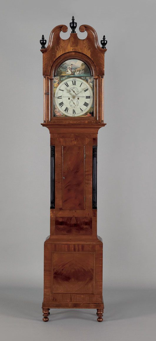 Pennsylvania late Federal mahogany tall-case clock, circa 1830, inscribed ‘Johnston & Lewis, Philadelphia,’ the broken arch bonnet enclosing an eight-day works with painted face over a case with ebonized columns and turned feet, 103 inches high, est. $3,000-$5,000. Image courtesy of Pook & Pook Inc.