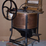 A gas engine could power this Morrison washing machine, which has a copper tub. Power was transferred by belt to the wheel on the washing machine. Image courtesy of Old Hat Auctions, Houston Texas, and LiveAuctioneers archive.