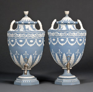 Pair of Wedgwood solid blue jasper tea urns and covers, late 18th century, each with applied white foliate and floral designs, impressed marks, height 18 inches, est. $15,000-$25,000. Image courtesy of Skinner Inc.
