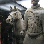 Terracotta soldier with horse displayed behind glass. Photo taken in 2005 by Robin Chen.