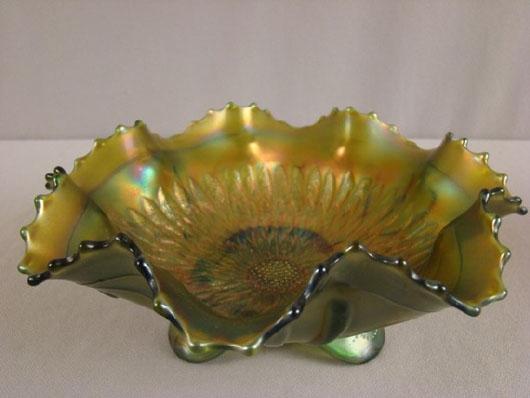 >Northwood green Carnival glass Sunflower bowl with spatula feet, 8 1/2 inches, estimate:  $50-$100. Image courtesy of Strawser Auction Group.