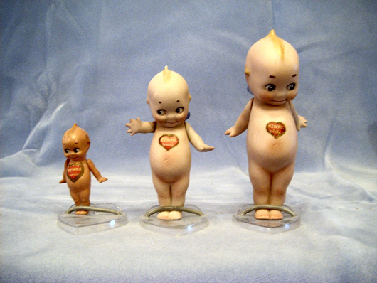 One lot comprising three Rose O'Neill Kewpie dolls (3-6 inches tall) with original labels. Image courtesy of Browne Auction Specialists.