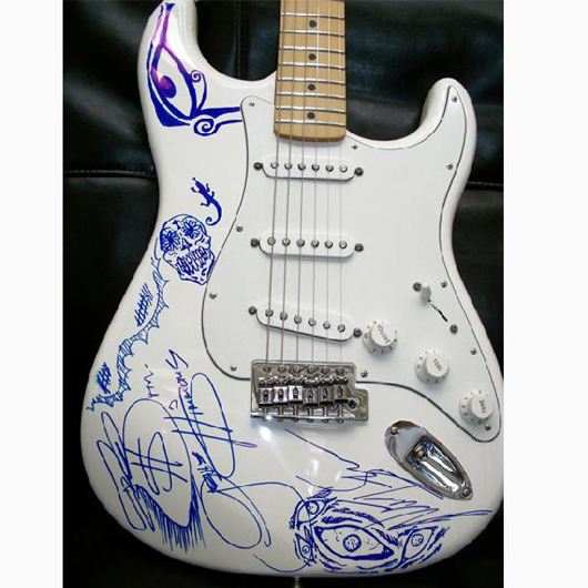 Fender® Stratocaster® guitar personally decorated and autographed by the one and only Gene Simmons, co-founder of KISS, and his son Nick. Estimate $3,000-$7,500. Image courtesy of LiveAuctioneers.com and Little Kids Rock.