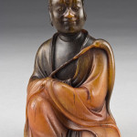 Chinese carved rhino horn Luohan holding a fuchen, 4 3/4 inches high, circa 19th century, price realized: $85,750. Image courtesy of Dallas Auction Gallery.