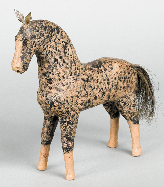 Peter Brubaker (Lancaster County, Pa., 1816-1898), carved and painted figure of a horse with dappled body and tin ears, 9 3/4 inches high. Illustrated in Machmer's ‘Just For Nice,’ figure 58. Est. $5,000-$9,000. Image courtesy of Pook & Pook Inc.