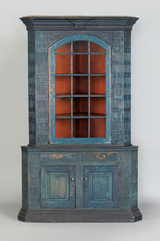 Pennsylvania painted poplar two-piece corner cupboard, ca. 1780, retaining an old blue painted surface, the interior also retaining an original vibrant salmon paint, 90 1/2 inches high x 57 inches wide. Est. $10,000-15,000. Image courtesy of Pook & Pook Inc.