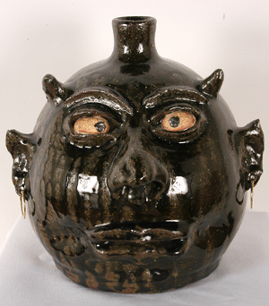 Devil face jug by the renowned Lanier Meaders, tobacco-spit glaze with gorgeous drips. Image courtesy of Slotin Folk Art Auction.