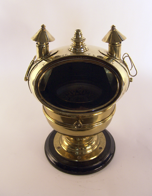 Rare 19th-century yacht binnacle with original gimbaled compass by maker F.M. Moore of Belfast and Dublin. Mounted to a timber base. 12 inches wide x 15 1/2 inches tall. Estimate: $2,500-$3,500. Image courtesy Boston Harbor Auctions.