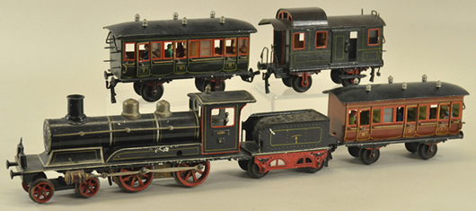 The auction includes a bumper crop of Marklin toys, trains, stations and accessories, including this gauge 1 clockwork train set, 11 inches long, with 4-4-0 hand-painted tin, steam-outline engine with tender, two passenger cars and caboose. Estimate $5,000-$7,000. Bertoia Auctions image.