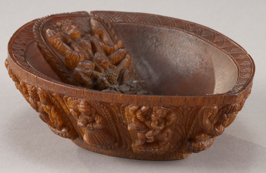 Rare Vaishnava carved rhinoceros horn libation cup. The interior yoni form vessel carved in relief with a four-armed Vishnu crouched on the feathers of his Garuda, both shown on a seated on a lotus blossom. Estimate: $100,000-$120,000. Image courtesy of Dallas Auction Gallery.