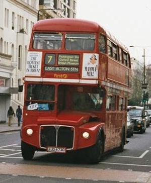 April 2002 image of First London's Routemaster RML 2473 (JJD 473D), operating from Westbourne Park garage, as it made its approach to Ladbroke Grove Station en route to East Acton Station. The bus was withdrawn in 2005. Photo by Kotasik, courtesy Wikimedia Commons.