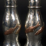 Copper colored fish are applied to these sterling silver shakers. Image courtesy of Capo Auction.