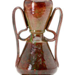 George Ohr 8 1/2-inch vase with two ribbon handles, red and green mottled glaze, stamped