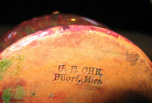George Ohr mark incised under the base of the vase. Image courtesy LiveAuctioneers.com Archive and Craftsman Auctions.