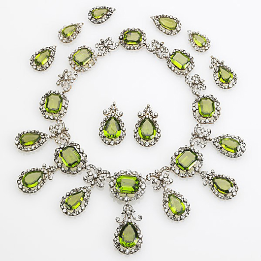 The largest octagonal gem in this peridot and diamond suite weighs 33 carats and transforms into a brooch. Estimated at $60,000-$80,000, the suite sold for $158,600. Image courtesy of Rago Arts & Auction Center.