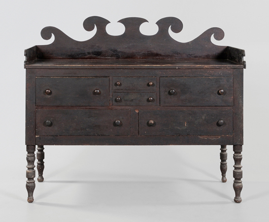There are six dovetailed drawers in this sideboard that descended in the Burgner family of Greene County, Tenn. From the 1840s and with its original varnished surface, original and ornate splash panel and original drawer pulls, the  sideboard sold for $33,350 (est. $20,000-$30,000). Image courtesy of Brunk Auctions.