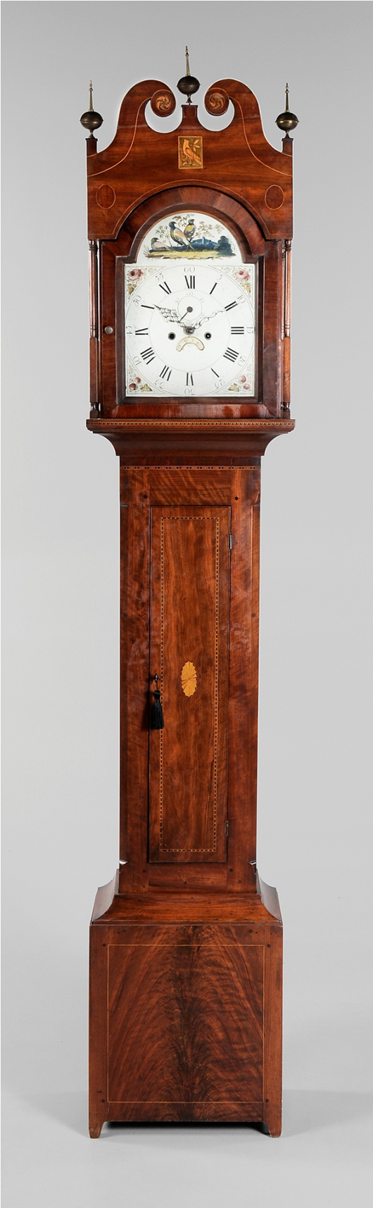 Dating to 1795-1805, this 100 1/2-inch-high case clock from Northern Virginia or Baltimore sold for $16,100 (est. $20,000-$30,000). Look carefully for the proud bird inlaid in the tympanum. Image courtesy of Brunk Auctions.