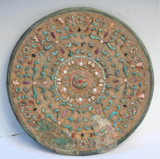 Chinese Tang Dynasty gilt bronze mirror with semiprecious stones, unmarked, 8 inches diameter. Estimate:  $12,000-$14,000. Image courtesy of Auctions by Showplace Antique & Design Center.
