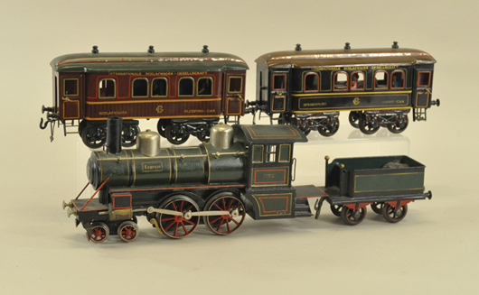 Bing 1 gauge train set with “Express” electric locomotive and tender, Speisewagon dining car, Wagons-Lits sleeping car, $12,650. Bertoia Auctions image.