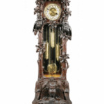 Owls, oak leaves, acorns and ferns are carved on the sides and base of this tall case clock. The 7-1/2-foot-tall clock sold for $14,000. The works are marked ‘Hawina,’ a German trademark.