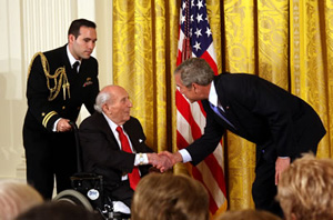 Financier and philanthropist Roy Neuberger receiving the National Medal of Arts from President George W. Bush in 2007. Image courtesy of Wikimedia Commons.