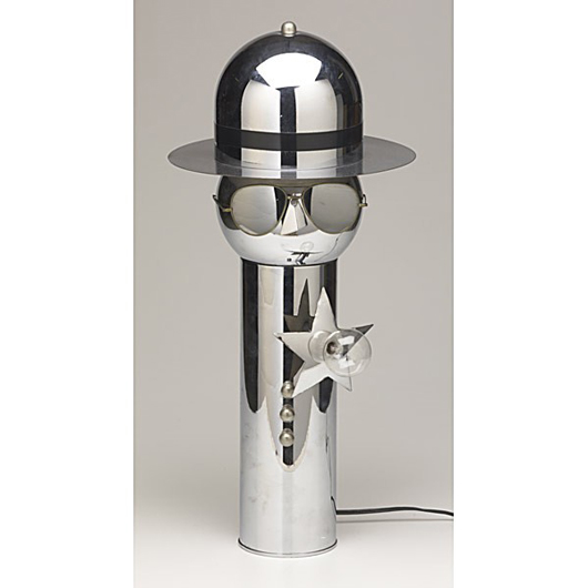 Torino (Italy), chrome policeman table lamp. Estimate: $400-$600. Image courtesy of Rago Arts and Auction Center.