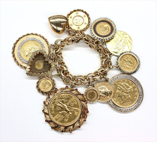 14K yellow gold charm bracelet with 12 charms, including commemorative coins and medallions, $9,480. Clars Auction Gallery image.