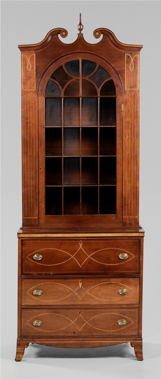 The ‘fluted pilaster group’ consisted of early 19th-century furniture makers from the Catawba River Valley of North Carolina. This secretary-with-bookcase from 1800-1810 is one of their few surviving examples of their later work when they inlaid only the pilasters. The 115-inch-high secretary sold  for $55,200. Image courtesy of Brunk Auctions.