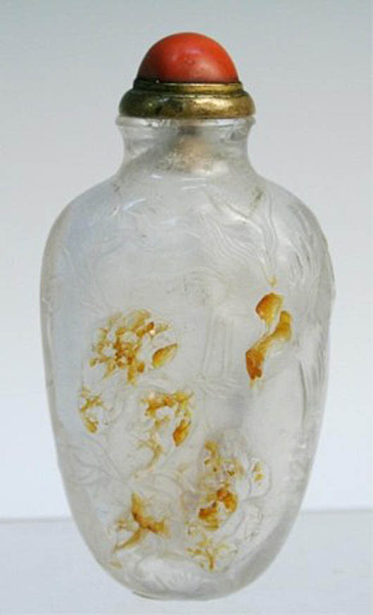 Carved snuff bottle with natural brown skins and carved bamboo scene, rock crystal with coral stop, China, 19th century; unmarked, 3 3/8 inches high x 1 3/4 inches wide x 1 inch deep. Estimate: $2,000-$2,500.