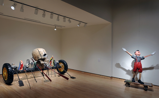 Shown (left to right): ‘Wheat Fields,’ 1989, painted bronze with patina and pigment, 80 x 172 x 99 inches, and ‘White Gloves, Four Wheels,’ 2007, oil-based enamel and charcoal on wood, 81 1/2 x 58 1/4 x 24 inches. Image courtesy of Frederik Meijer Gardens & Sculpture Park.