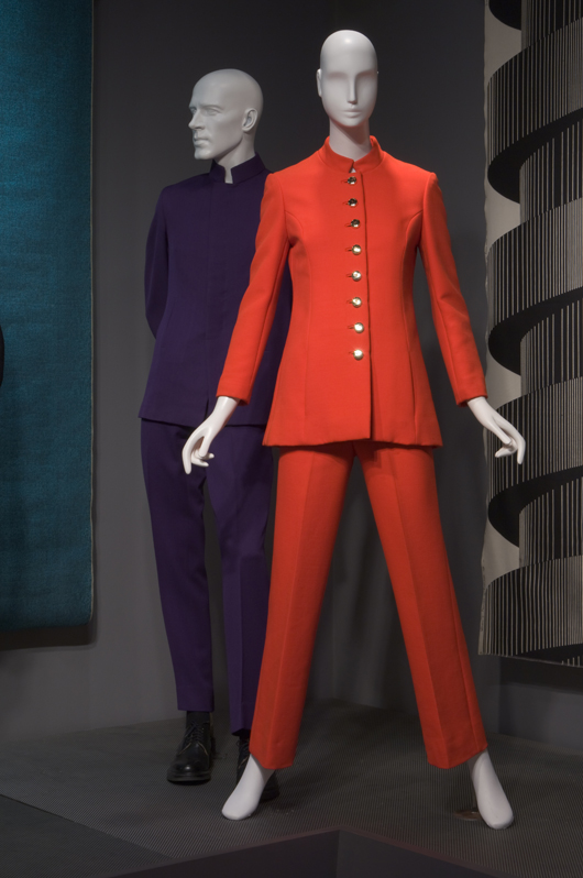 A purple wool man’s suit by Jacques, circa 1965, and a red wool woman’s suit by Tape Measure, circa 1967, are displayed together in ‘His and Hers,’ an exhibit at the Museum at the Fashion Institute of Technology in New York. Image courtesy Fashion Institute of Technology.