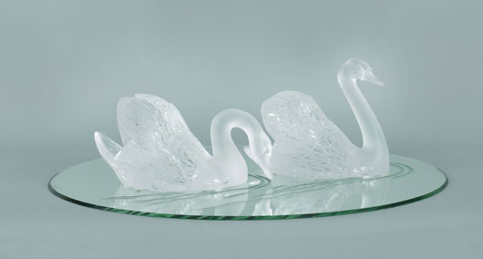 Lalique frosted glass swans on a lake group, 9 1/4 inches high and 7 inches high; mirror base: 32 3/4 inches x 22 1/4 inches. Estimate: $3,000-$5,000. Image courtesy Pook & Pook Inc.