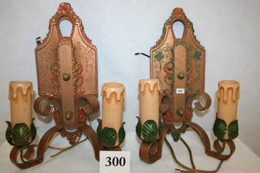 Pair of wall sconces signed ‘Lincoln,’ decorated and painted, 11 inches high. Image courtesy of Old Barn Auction.