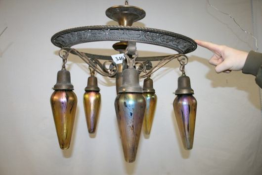 Five scrolled drop brass chandelier with iridescent unsigned Loetz-style bullet shades, 18 inches high x 20 1/2 inches in diameter. Image courtesy of Old Barn Auction.