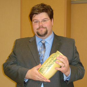Peter D. Gehres, new owner of Belhorn Auctions, cradles a choice Overbeck Pottery vase, which was exhibited at an American Art Pottery Association convention. Image courtesy of Belhorn Auctions.