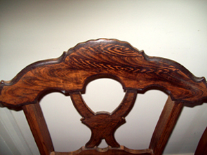 This well-done rosewood grain painting on the crest rails of a pair of Renaissance chairs was overlooked by the park.