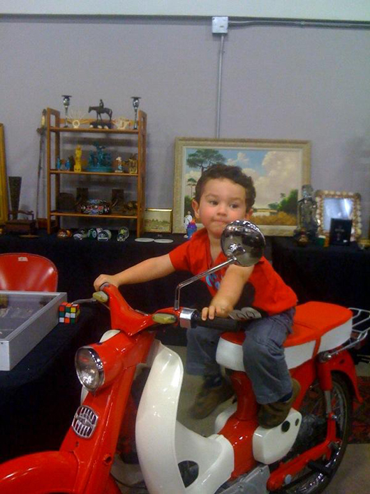 ‘You meet the nicest people on a Honda’ in Sonny Kimball’s booth. Image courtesy of West Palm Beach Antiques Festival.