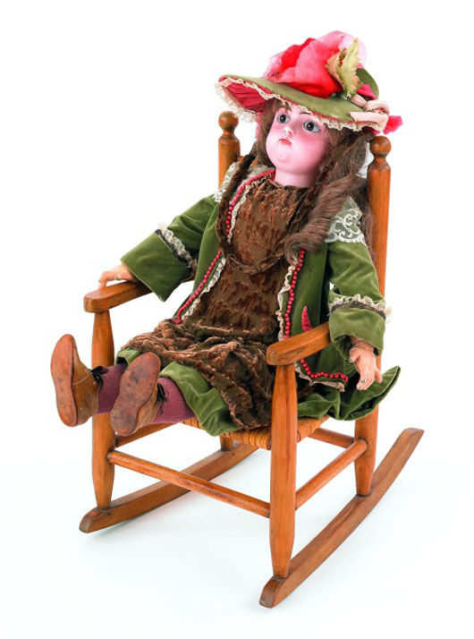 Francois Gaultier (French), bisque head doll, late 19th century, 29 inches high, together with a rocking chair: $3,318. Image courtesy of Pook & Pook Inc.