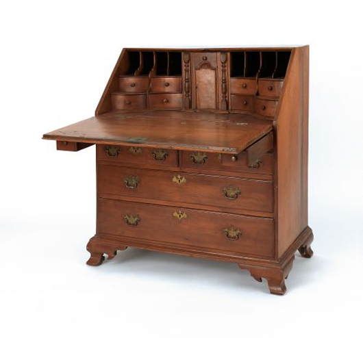 Pennsylvania Queen Anne walnut and cherry slant front desk, ca. 1765, the fall front enclosing an amphitheatre interior with carved prospect door and slide lid well over a case with two short and two long drawers supported by ogee bracket feet, 44 1/2" h., 37 1/2" w. $2,000-$4,000. Pook & Pook image.