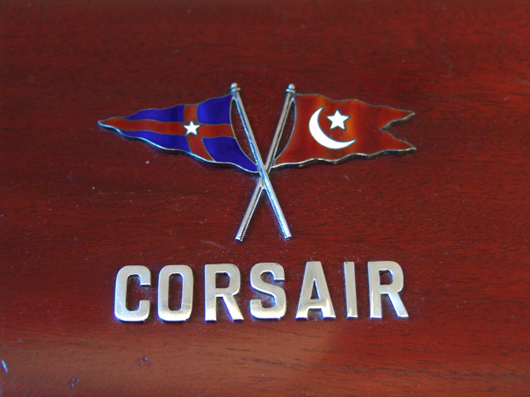 Cover of poker chips box.  Mahogany with sterling Corsair letters and New York Yacht Club burgee crossing staffs with the Morgan house flag emblazoned on front Image courtesy of Boston Harbor Auctions.