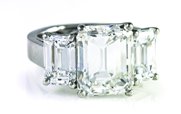Platinum and diamond ring containing an emerald-cut diamond weighing approx. 7.02 carats, a second diamond of 1.80 carats and a third weighing approx. 1.73 carats, $207,400. Leslie Hindman Auctioneers image.