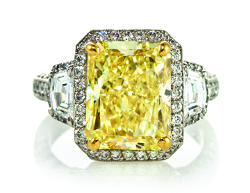 Platinum and fancy yellow diamond ring, Michael Beaudry, with one radiant-cut fancy yellow diamond weighing approx. 6.21 carats, two half-moon shape diamonds weighing approx. 0.67 carat total and numerous round brilliant cut diamonds approx. 0.66 carat total, $97,600. Leslie Hindman Auctioneers image.