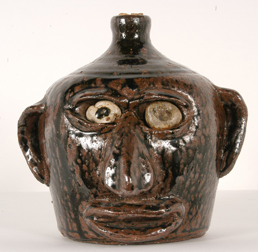 Iron sand glaze face jug by Southern pottery icon Lanier Meaders, titled ‘Rock Eyed Face Jug.’ Image courtesy of Slotin Auction.