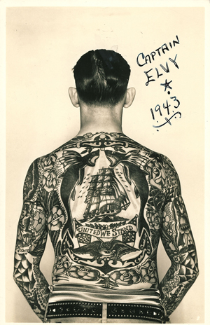 ‘Captain Elvy’ and his full body suit of tattoos. Elvy's back features a clipper ship, roses, flying fish, eagle, American flags, and a banner reading ‘United We Stand,’ circa 1940. Image courtesy Tattoo Archive, Winston-Salem, N.C.
