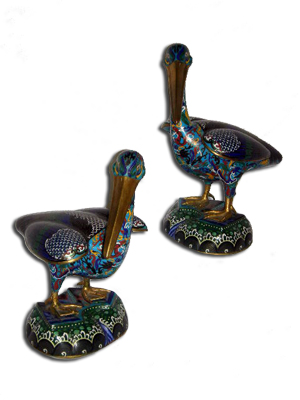 Pair of early 20th century Chinese cloisonné figures of pelicans with raised wings, mounted on triangular bases. Image courtesy Specialists of the South Inc.