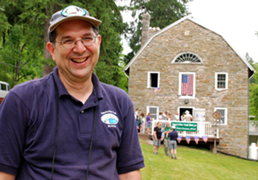 Larry Luxenberg, president of the Appalachian Trail Museum Society, greets visitors outside the 200-year-old gristmill that was renovated to house the group’s museum. Image courtesy of the Appalachian Trail Museum Society.