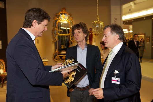 Sir Mick Jagger in conversation with friends at the inaugural Masterpiece Fine Art & Antiques Fair in London in June 2010. Image courtesy of Masterpiece Fair.